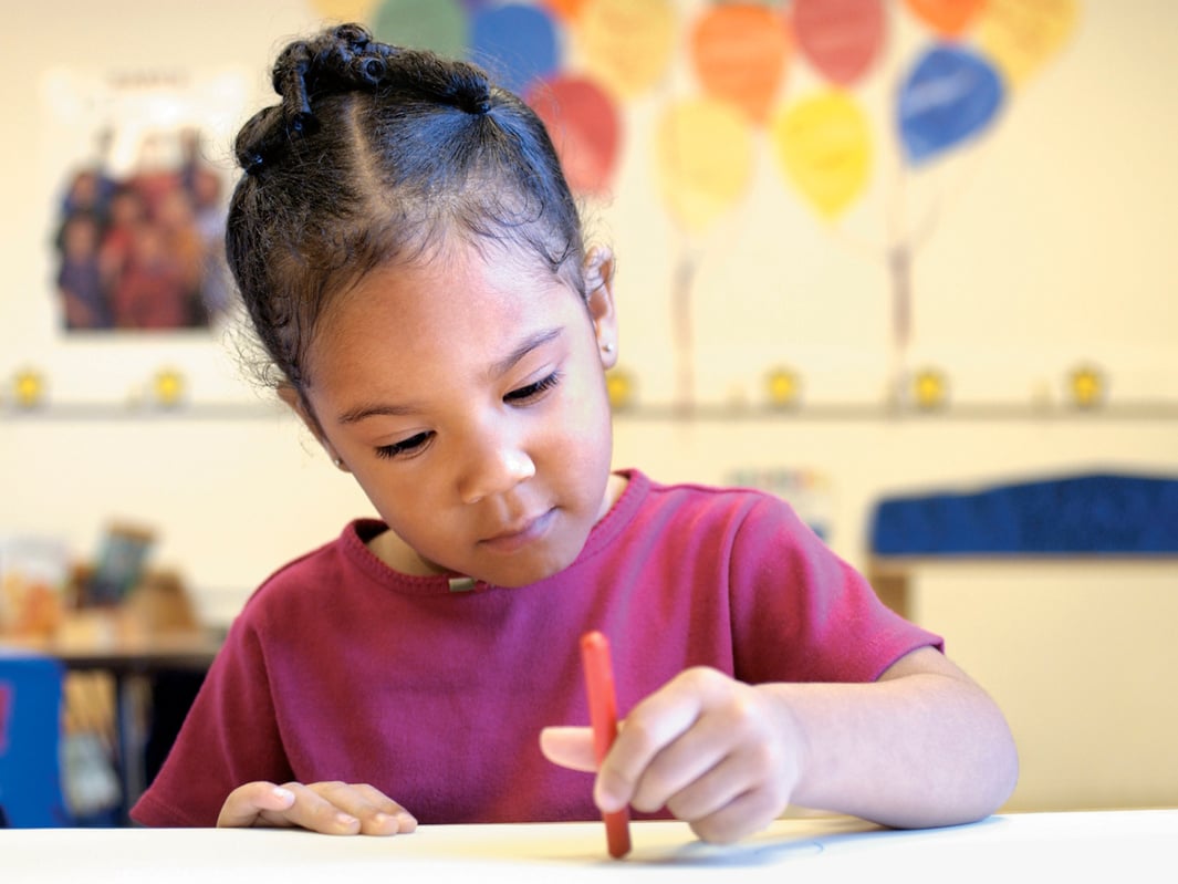 Girl coloring at a desk